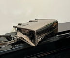 Louis Vuitton handbag top view, glossy metallic finish with hardware and structured rectangular shape