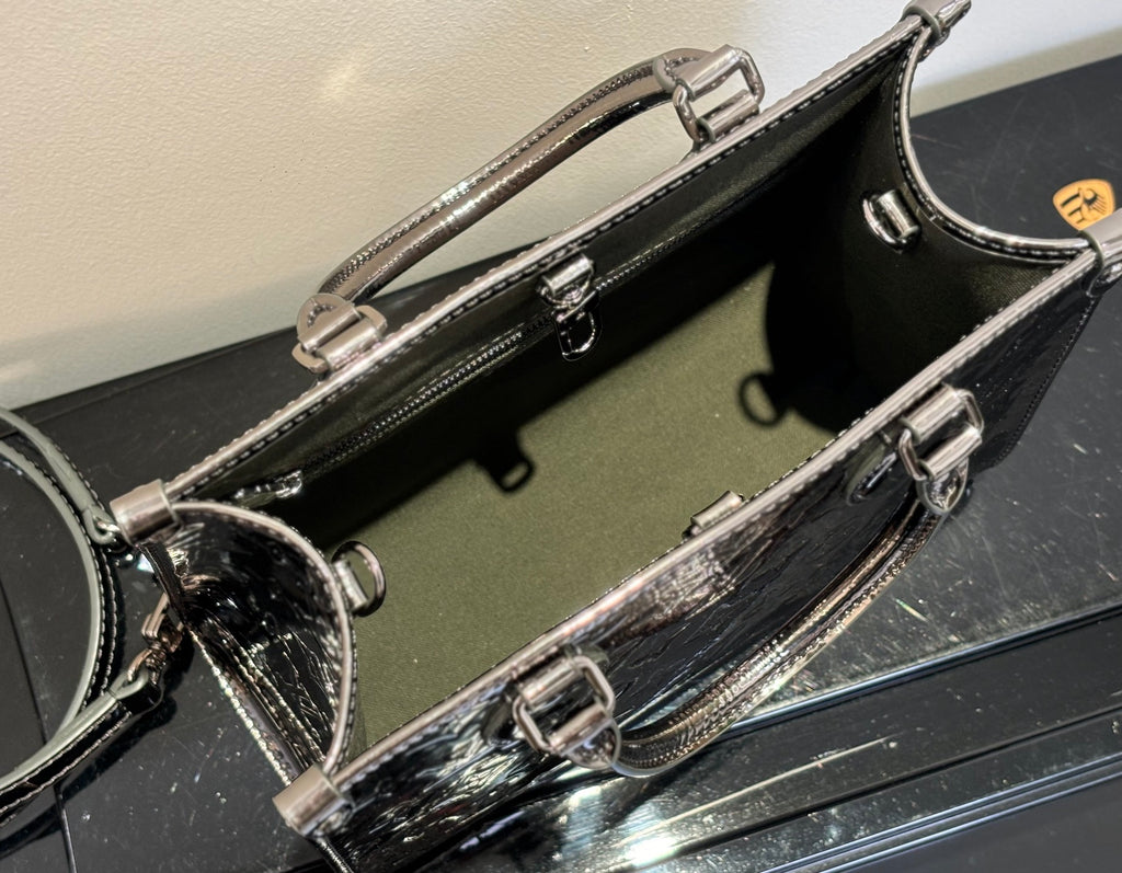 Louis Vuitton handbag interior view, dark lining with metal rings and zipper hardware