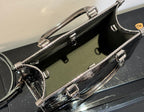 Louis Vuitton handbag interior view, dark lining with metal rings and zipper hardware