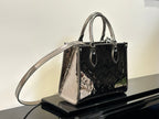 Louis Vuitton handbag with shoulder strap, glossy dark exterior with multicolor printed motifs