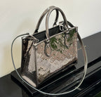 Louis Vuitton handbag with top handles and shoulder strap, glossy black and metallic multicolor pattern