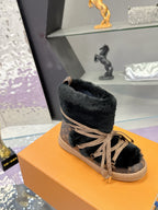 Black faux-fur lace-up ankle boot with tan laces and monogram side