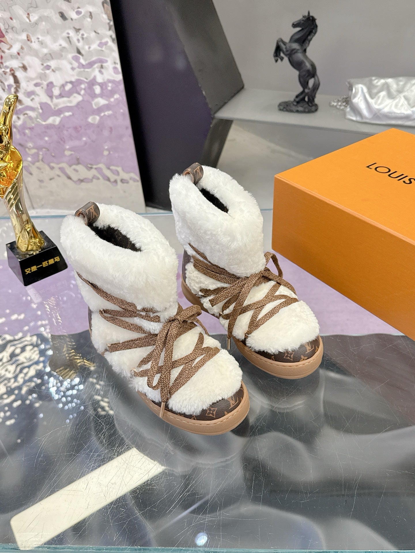 Louis Vuitton ladies faux-fur lace-up ankle boots, angled side view with brown laces
