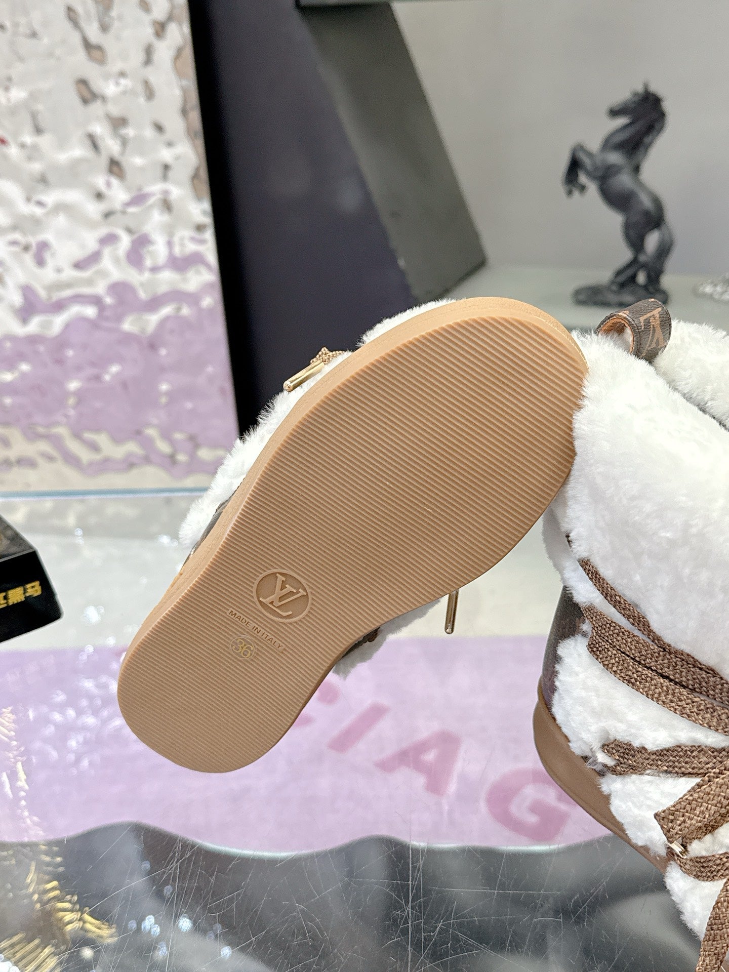 Louis Vuitton ladies faux-fur lace-up ankle boots, outsole view with logo embossed on sole