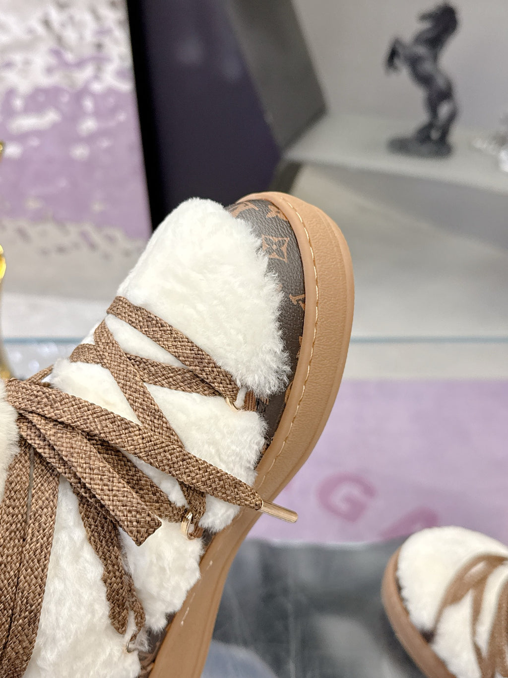 Louis Vuitton ladies faux-fur lace-up ankle boots, toe close-up with brown logo panel