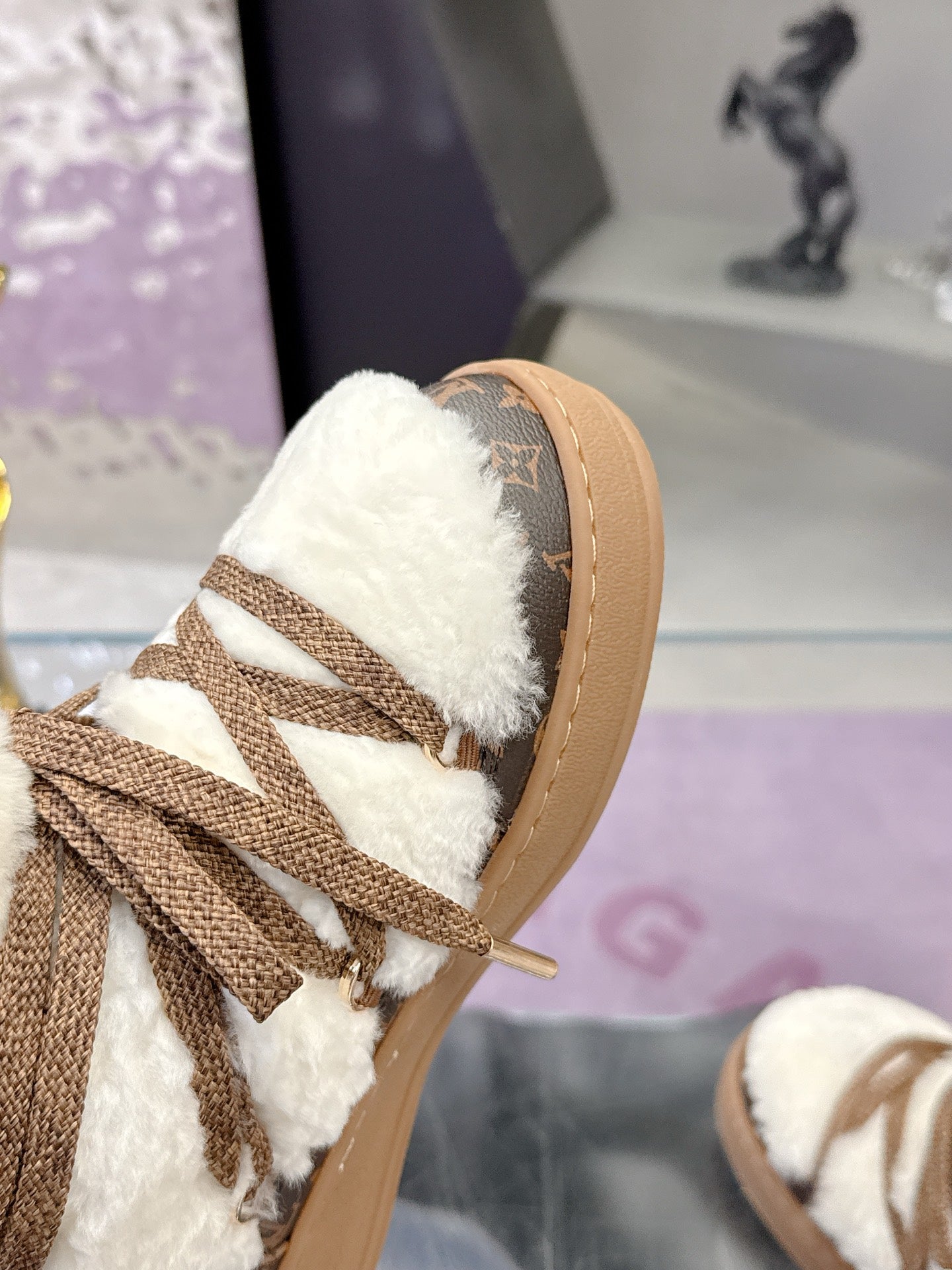 Louis Vuitton ladies faux-fur lace-up ankle boots, toe close-up with brown logo panel