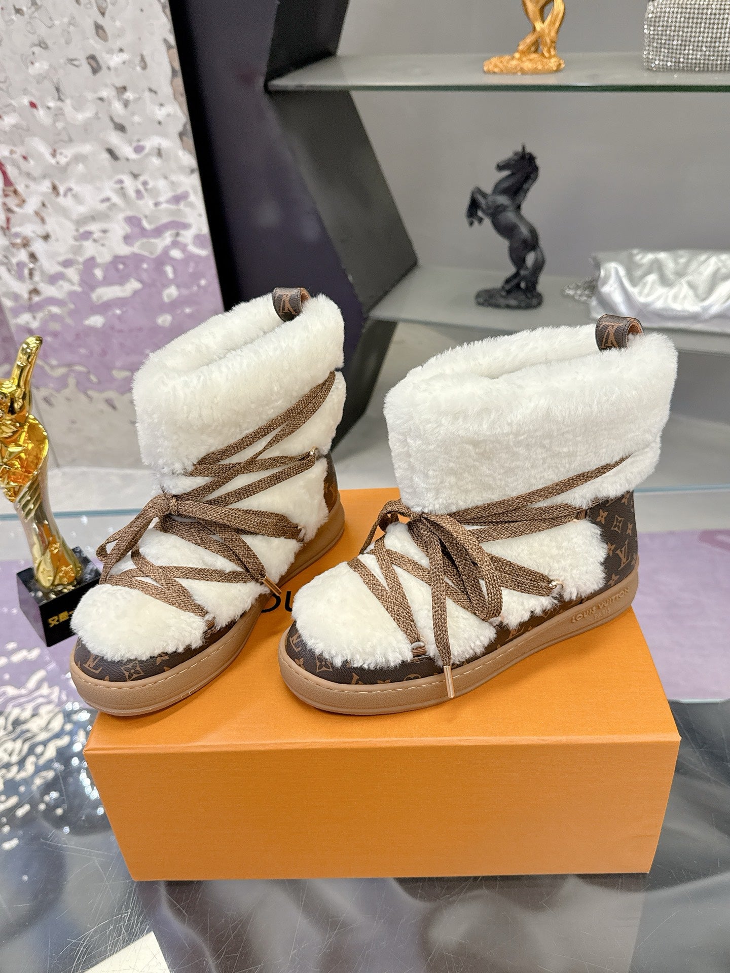 Louis Vuitton ladies faux-fur lace-up ankle boots, pair view with brown lace-up detail
