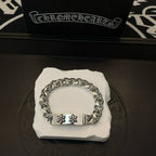 Silver-toned chain bracelet with rectangular center clasp and two cross-flower emblems