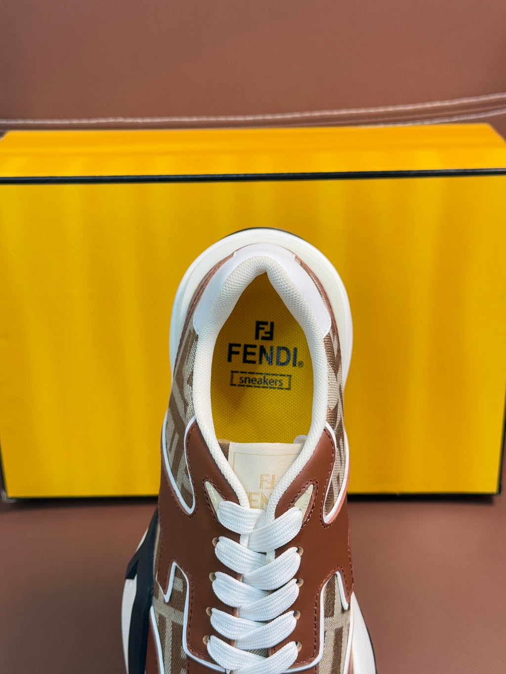 Fendi unisex sneakers with Fendi logo on tongue, white laces, and FF monogram panels