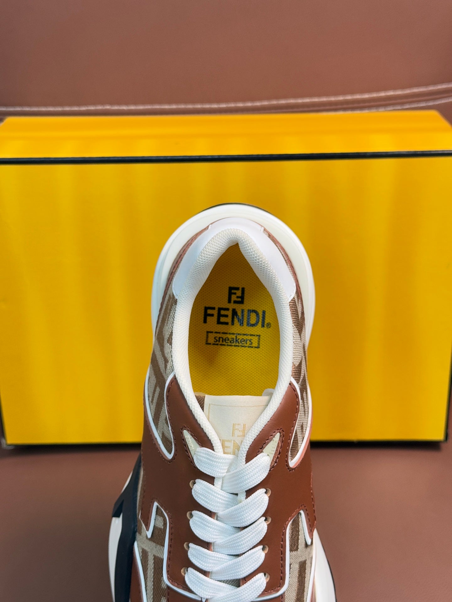 Fendi unisex sneakers with Fendi logo on tongue, white laces, and FF monogram panels
