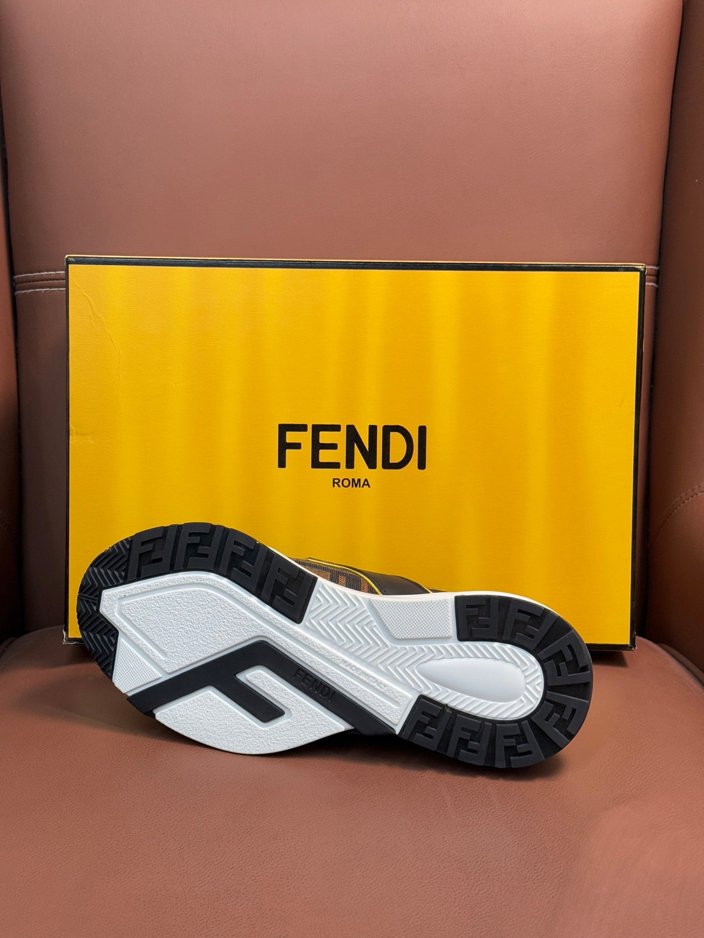 Fendi unisex sneaker outsole view, white tread with black FF logo pattern.