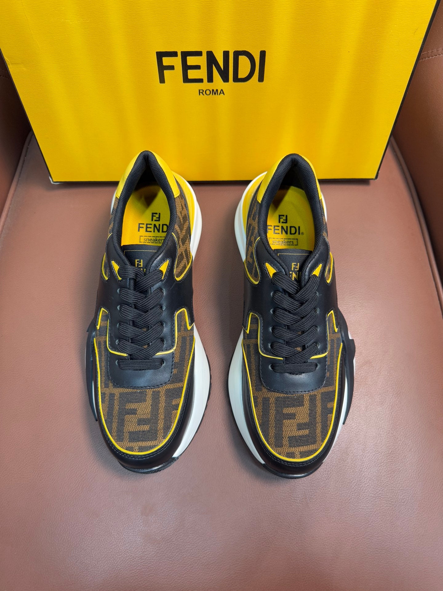 Fendi unisex sneakers in dark fabric with yellow trim and FF logo detail, lace-up style.