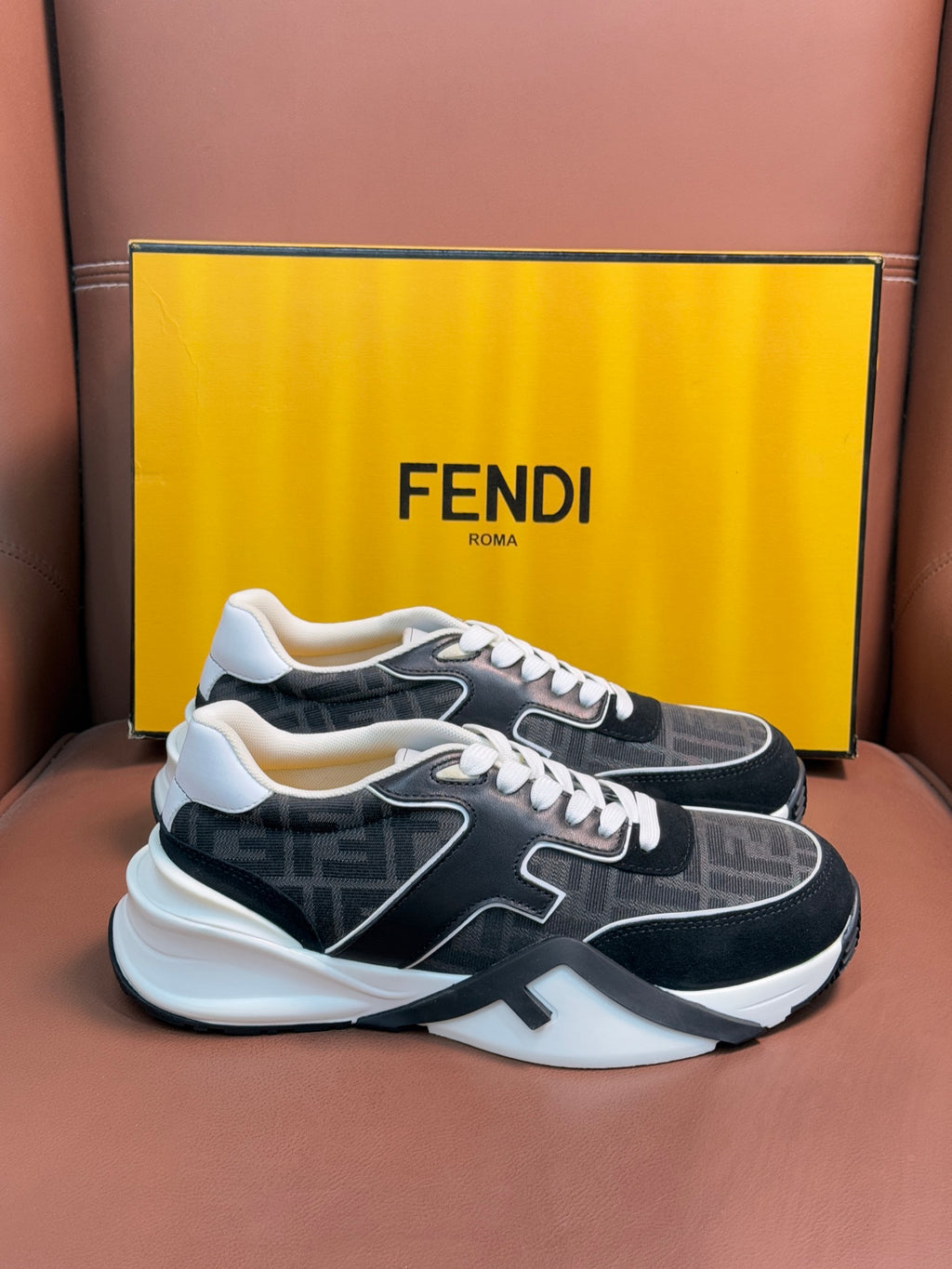 Black and gray Fendi unisex sneakers with white trim, chunky sole, and lace-up front.