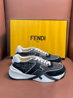 Black and gray Fendi unisex sneakers with white trim, chunky sole, and lace-up front.