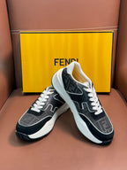 Black and gray Fendi unisex sneakers with white laces and thick white midsole, angled.