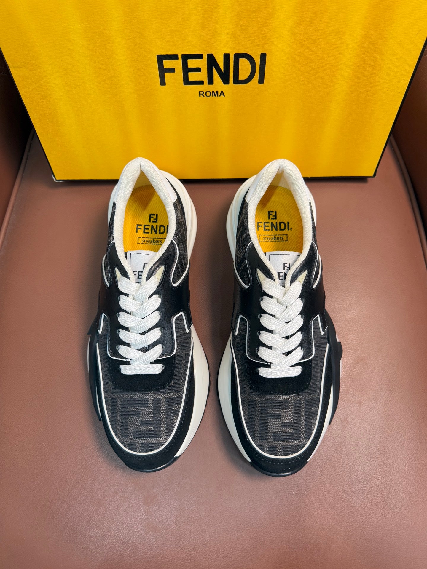 Black and gray Fendi unisex sneakers with white laces and contrast side panels.