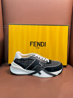Black and gray Fendi unisex sneakers with white laces and side logo detail, front view.