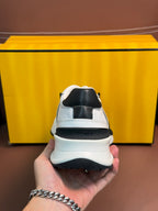 White sneakers with black heel trim and FENDI logo on back