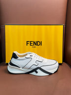 White lace-up sneakers with black logo stripe and textured side panel