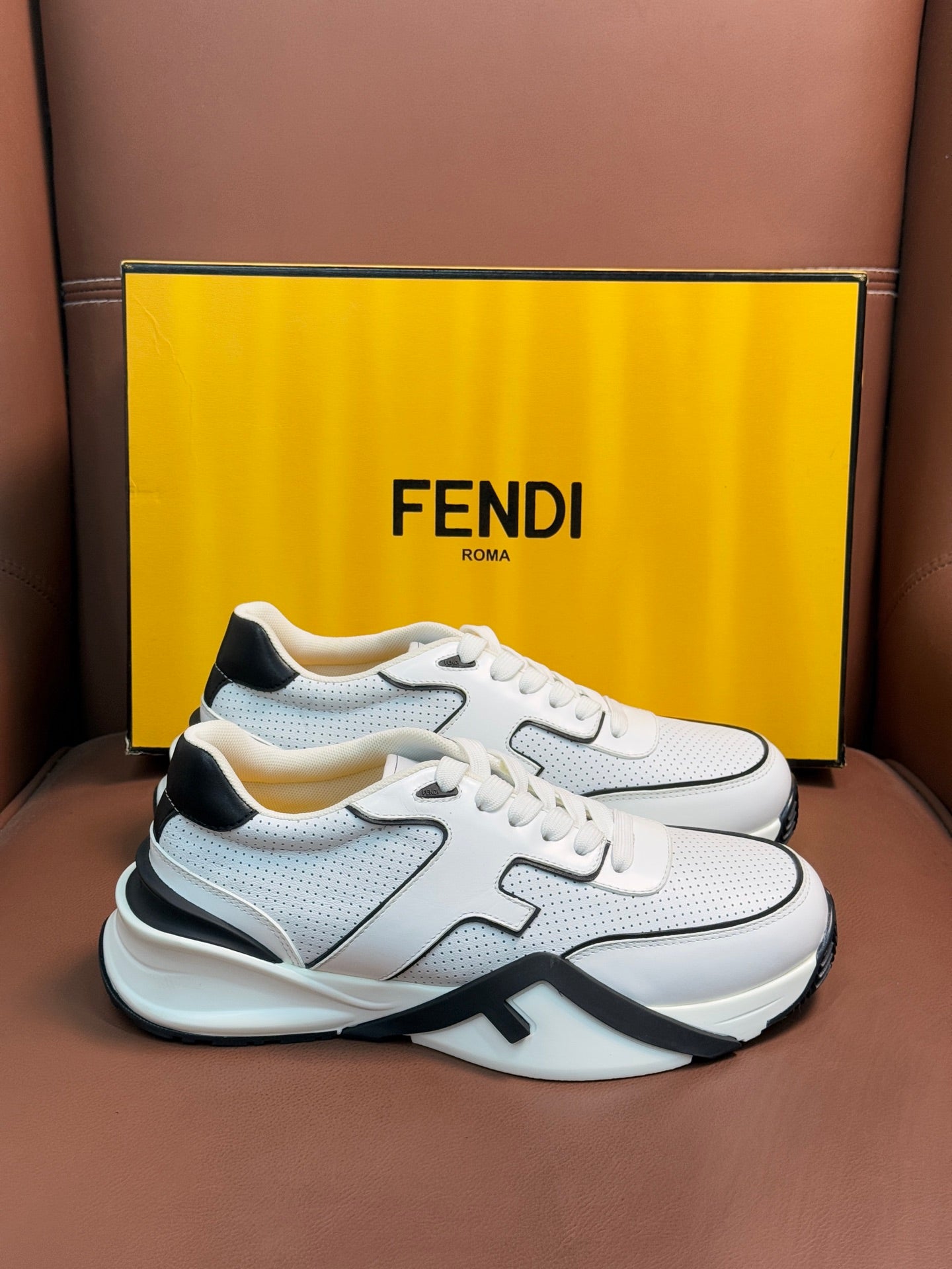 White sneakers with black logo stripe and padded collar, front view