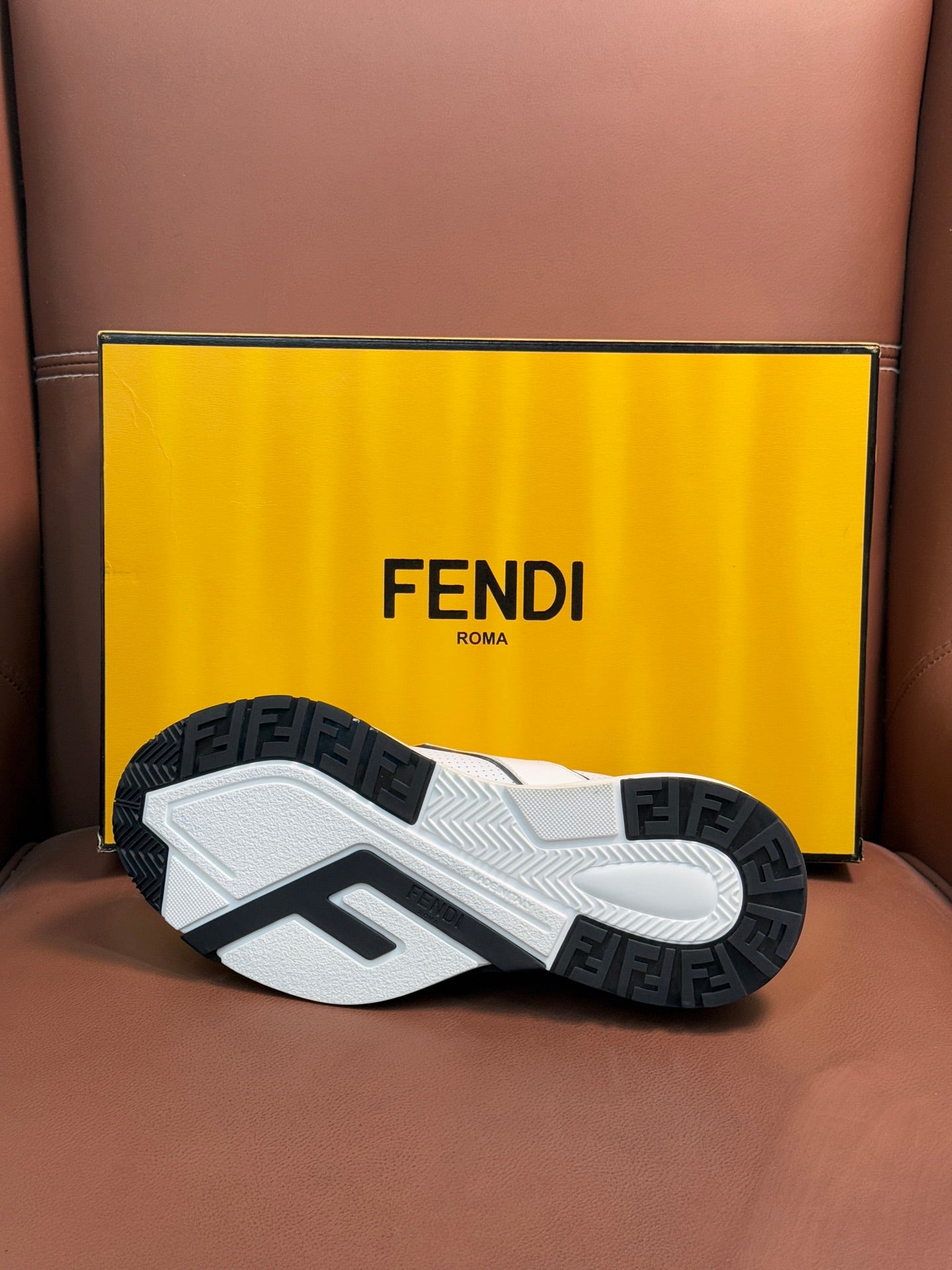 Sneaker outsole with black and Fendi lettering tread, white base