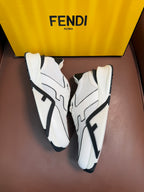 White lace-up sneakers with black logo panels, angled side view