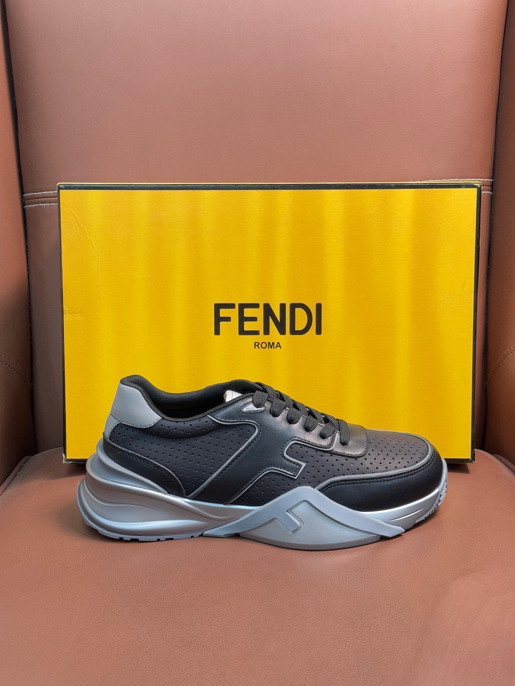 Fendi unisex sneakers, dark gray low-top lace-up with light gray panels and white midsole.