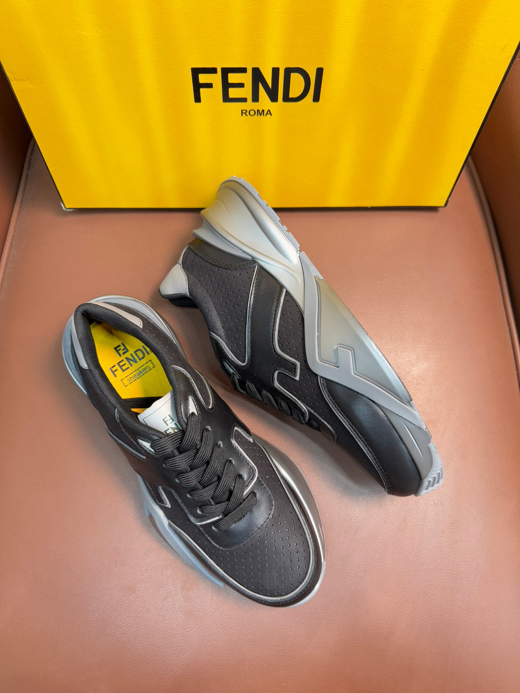 Fendi unisex sneakers, dark gray with light gray logo panels and white sporty sole.