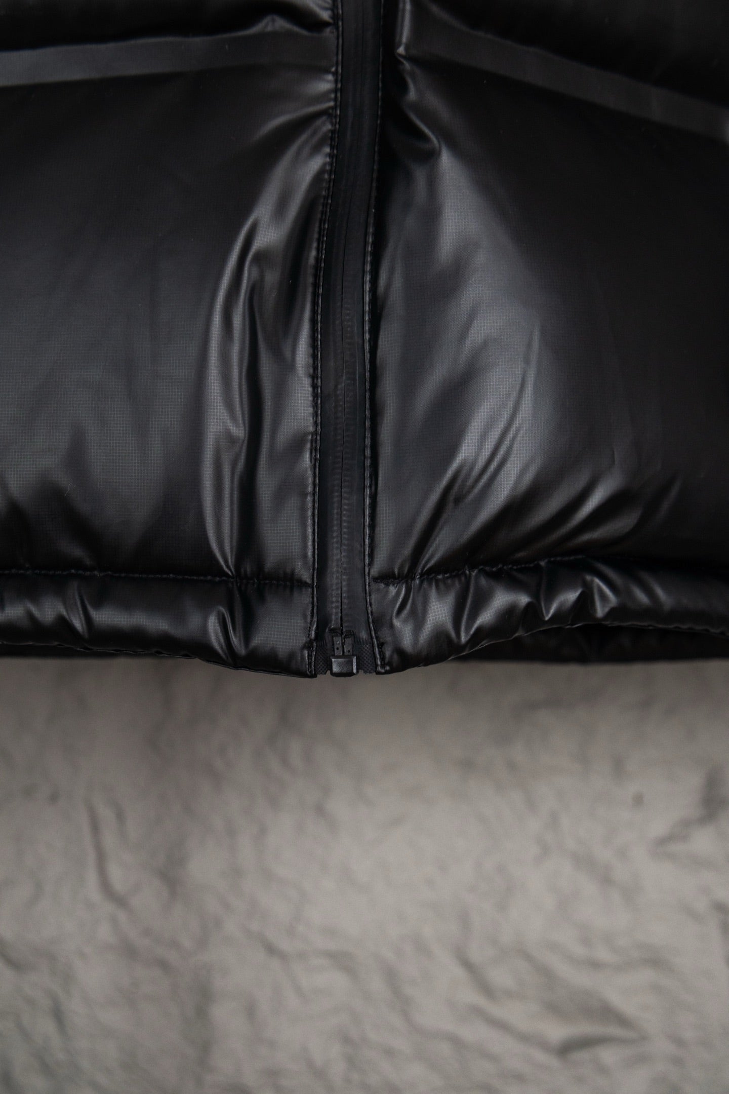 Prada long puffer jacket close-up of center zipper and stitched quilted seams