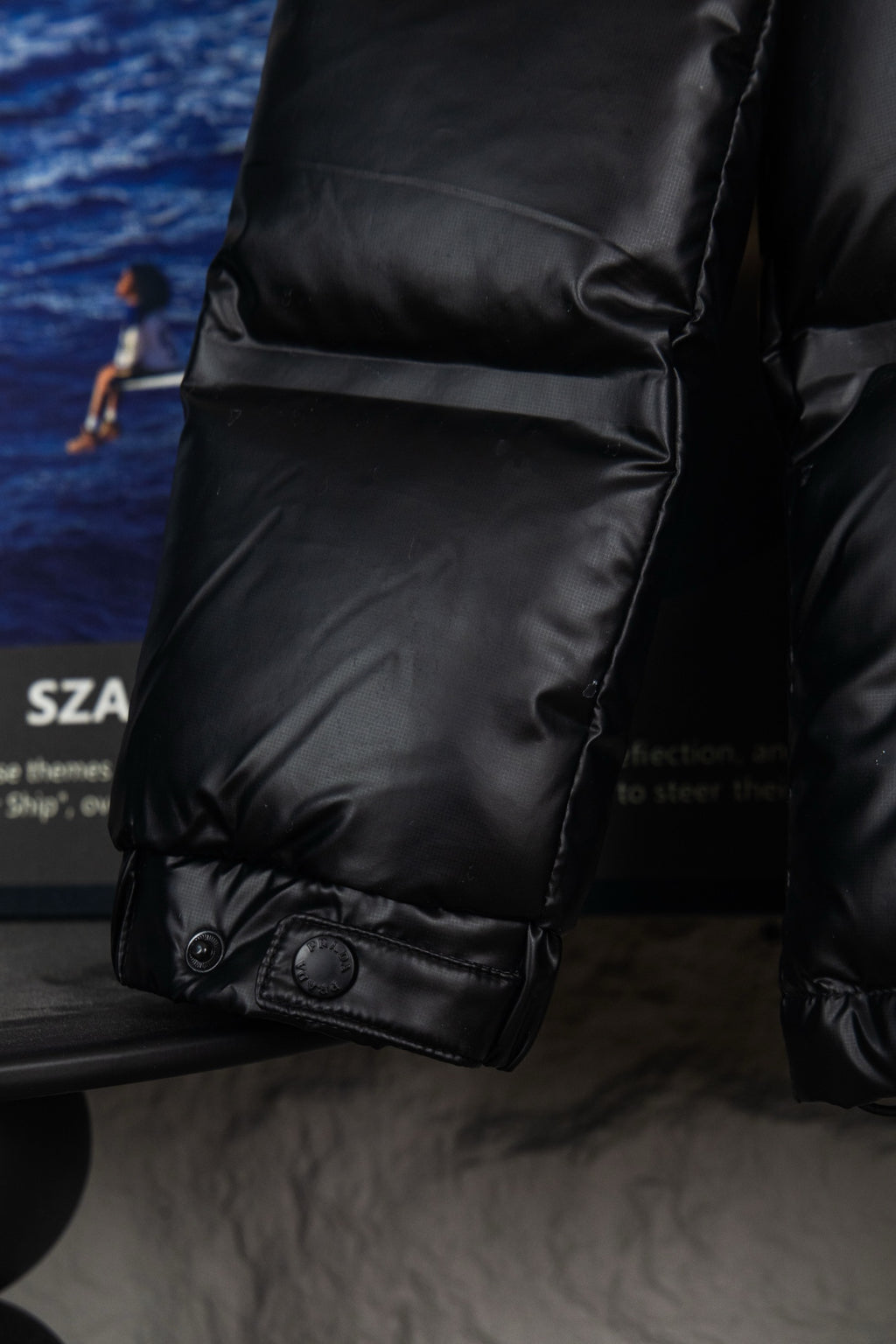 Prada long puffer jacket sleeve with cuff snap and padded pocket seam