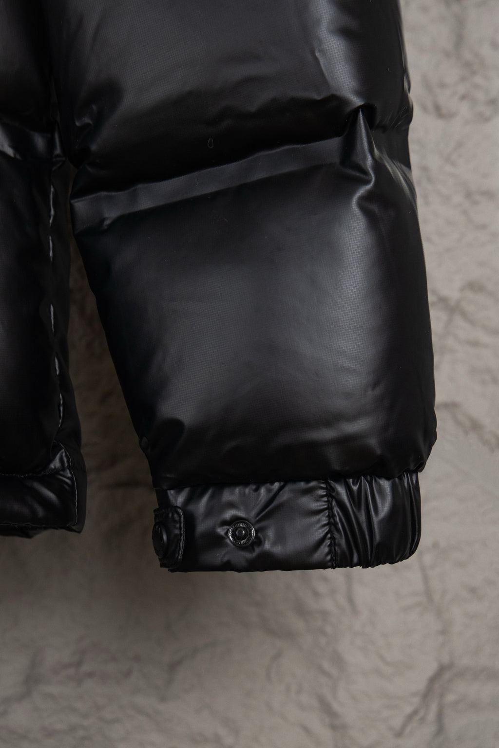 Prada long puffer jacket cuff with snap buttons on the lower sleeve