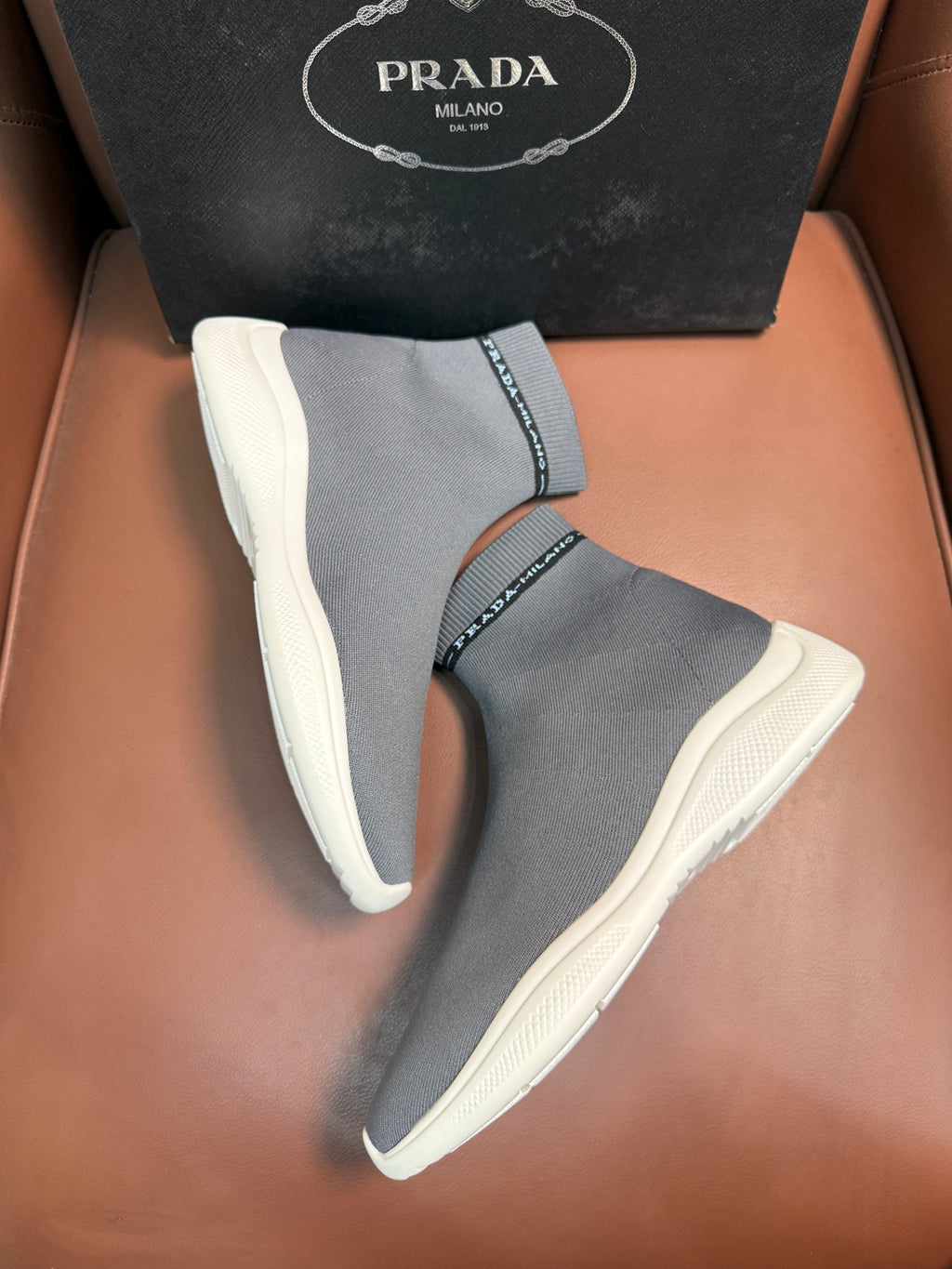 Prada unisex knit sock sneakers in light gray with textured white soles