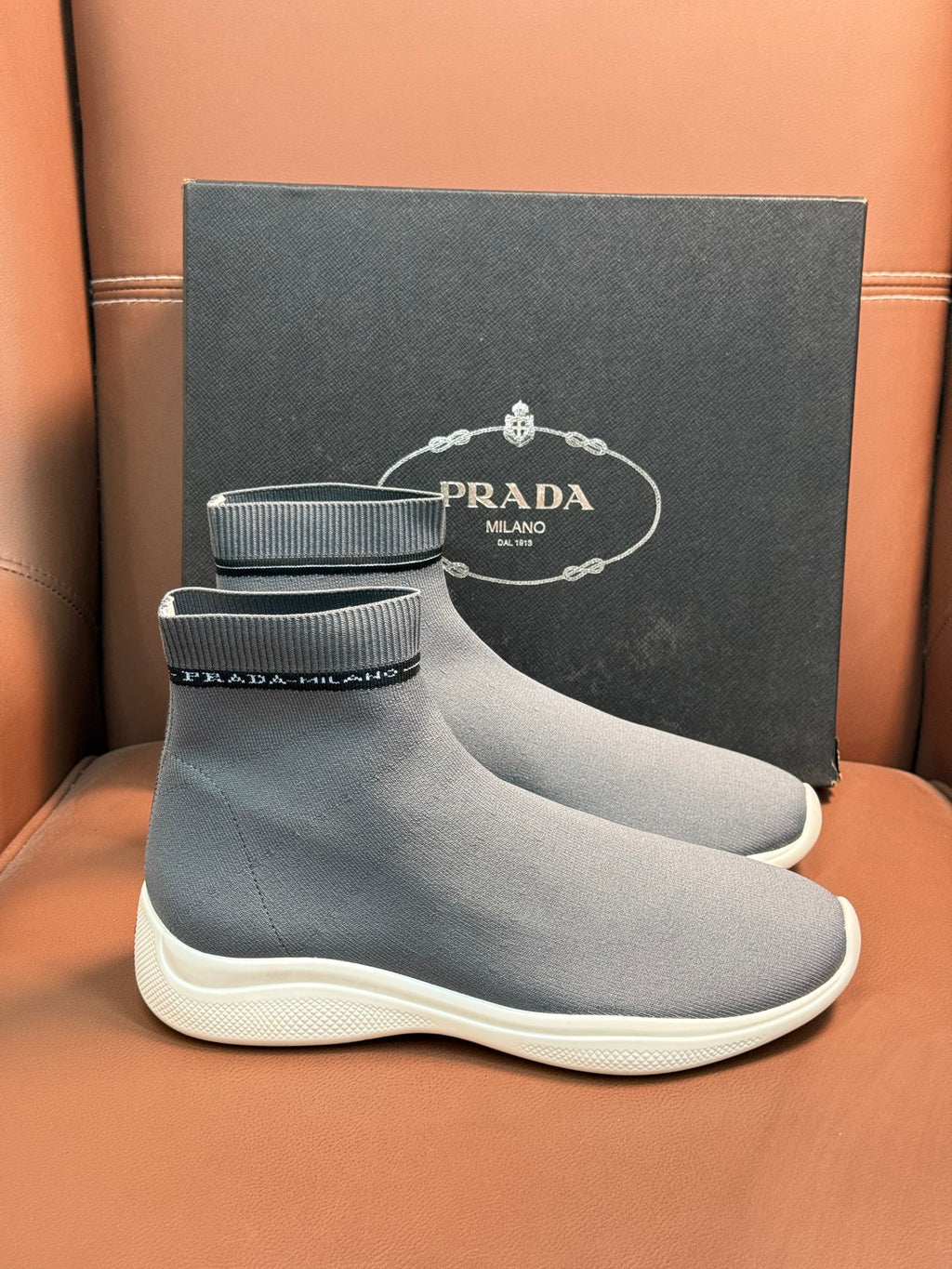 Prada unisex ankle sock sneakers in light gray with ribbed cuff and white sole