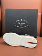 Prada unisex sneaker outsole in white with red heel accent and treaded grip