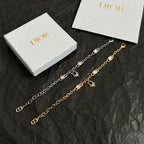 Charm bracelets with oval stones and D pendants, one silver-tone and one gold-tone