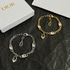 Two charm bracelets: silver-tone with D pendant, gold-tone with D pendant