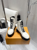 Louis Vuitton white high-top shoes pair, three-quarter angle on orange box