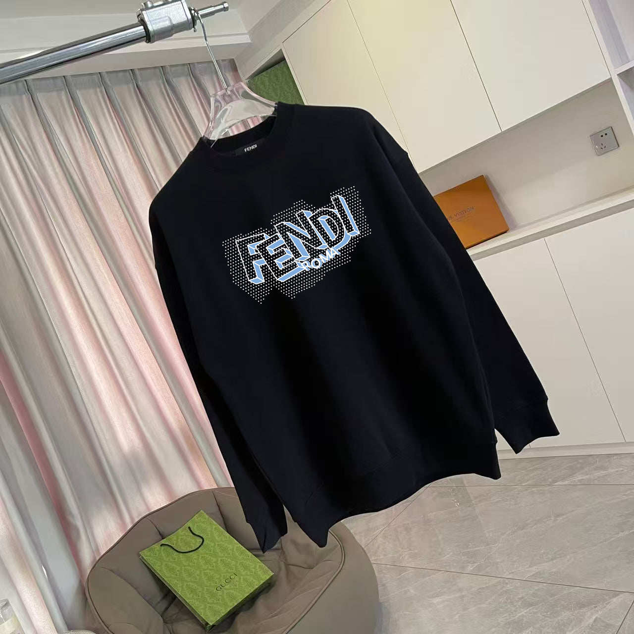 Long-sleeve crewneck sweatshirt, black, diagonal view with FENDI logo on chest.