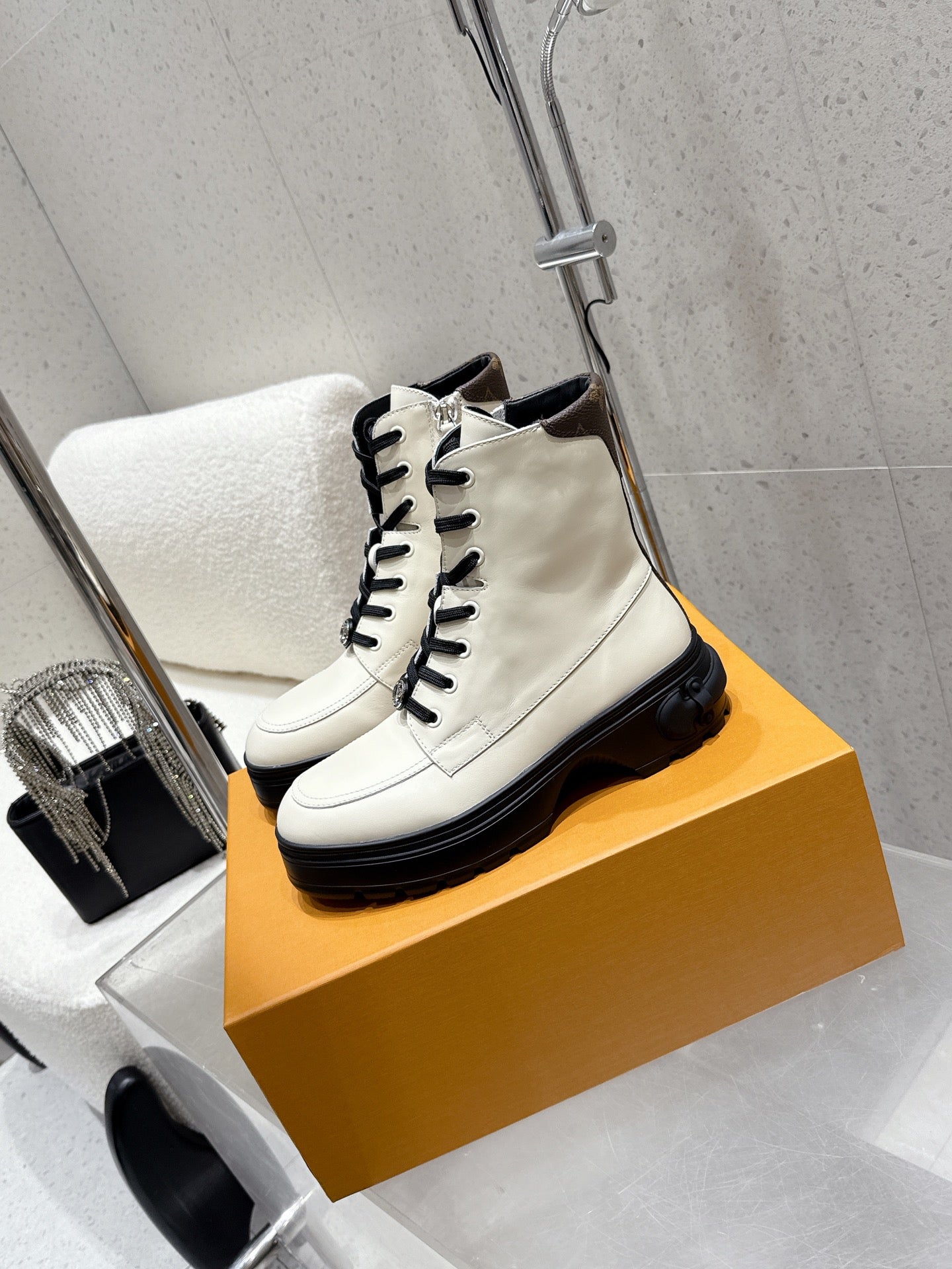 Louis Vuitton white high-top shoes, front quarter view, black sole