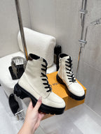 Louis Vuitton white leather high-top shoes, hand holding front on box