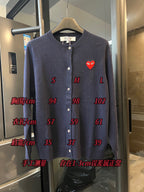 Dark navy knit cardigan with button front and small red heart patch on the left chest
