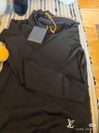 Louis Vuitton black long-sleeve pullover top, gold chain detail visible at neckline