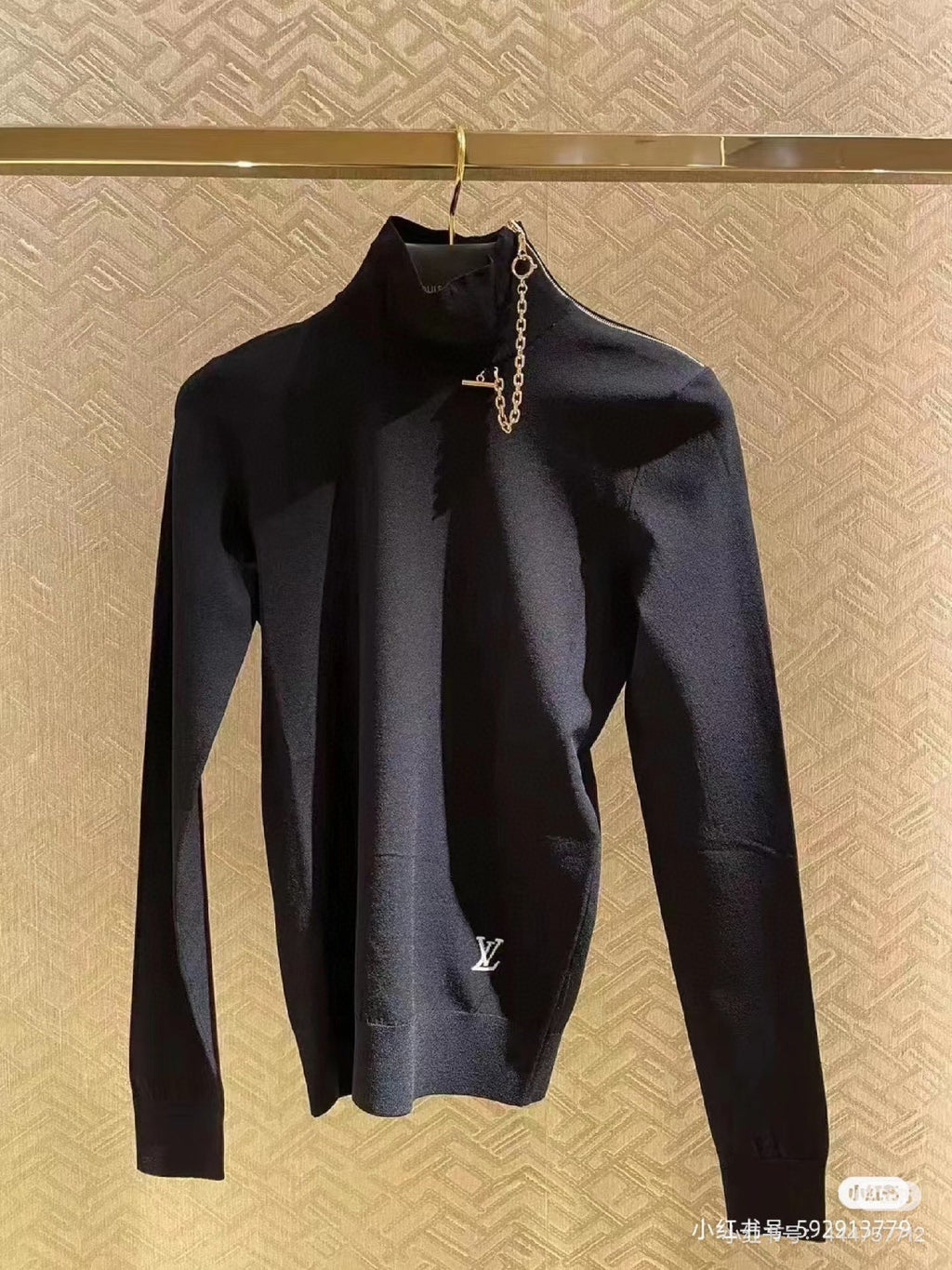 Louis Vuitton black long-sleeve mock-neck top with gold chain charm detail