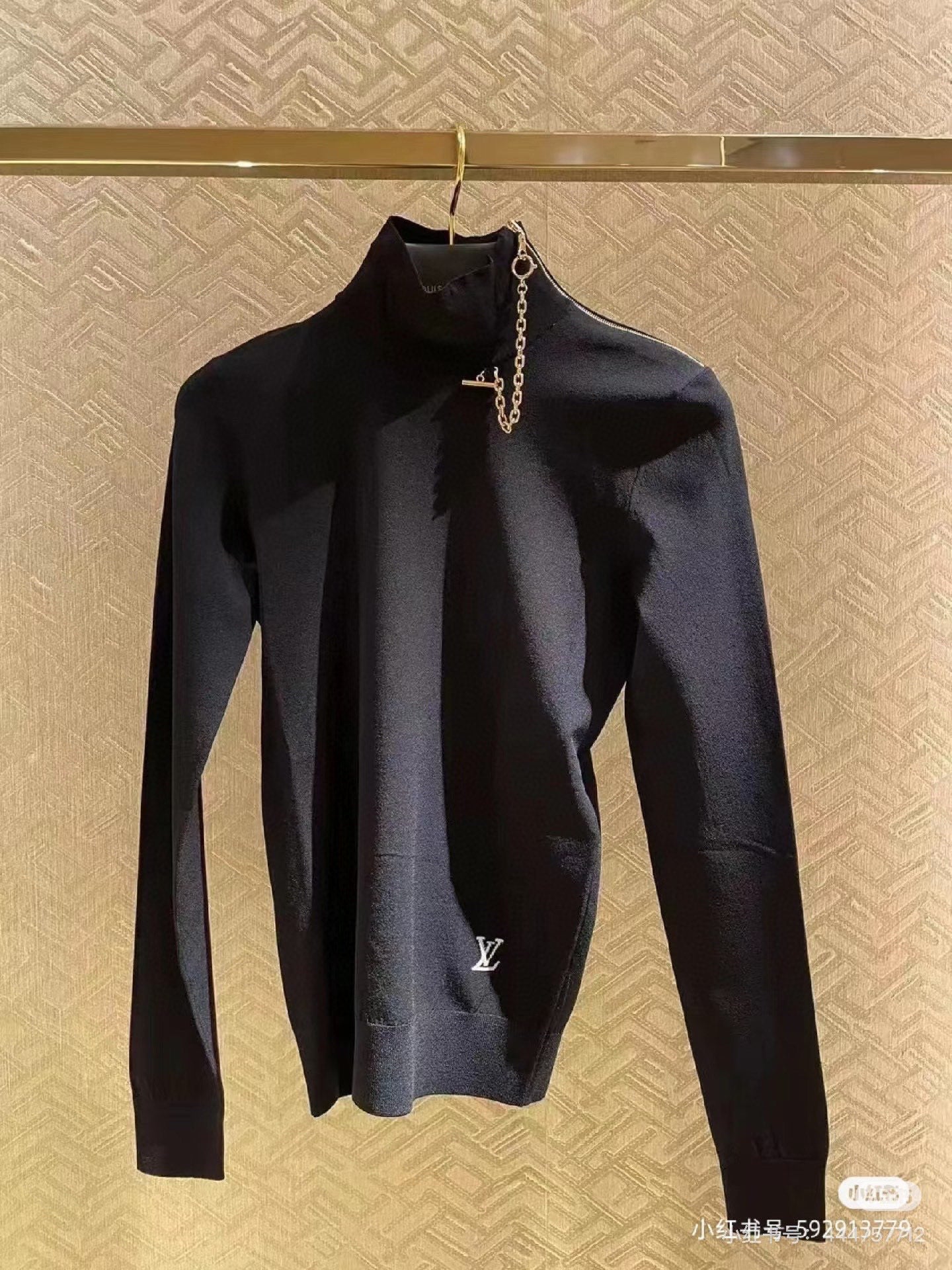 Louis Vuitton black long-sleeve mock-neck top with gold chain charm detail