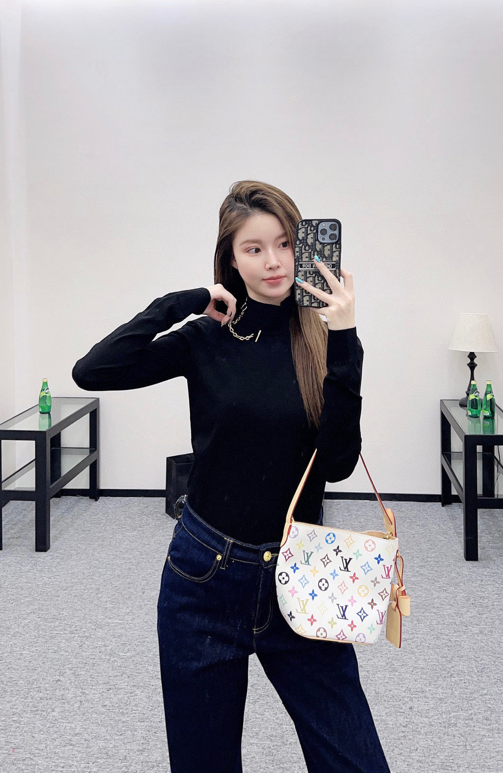 Louis Vuitton black long-sleeve mock-neck top, gold chain necklace and layered collar