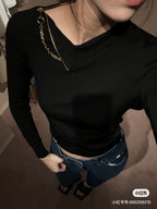 Louis Vuitton black long-sleeve top with gold chain necklace and small chest emblem