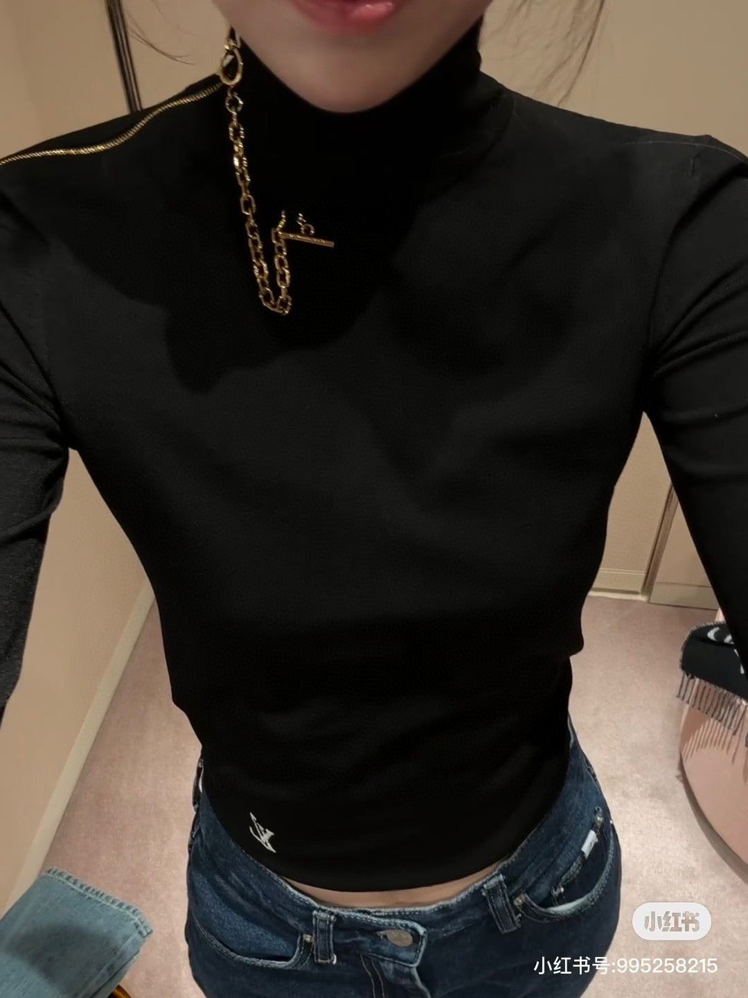 Louis Vuitton black long-sleeve mock-neck top with gold chain necklace and small logo