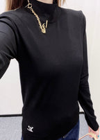Louis Vuitton black long-sleeve mock-neck top with layered gold chain at collar