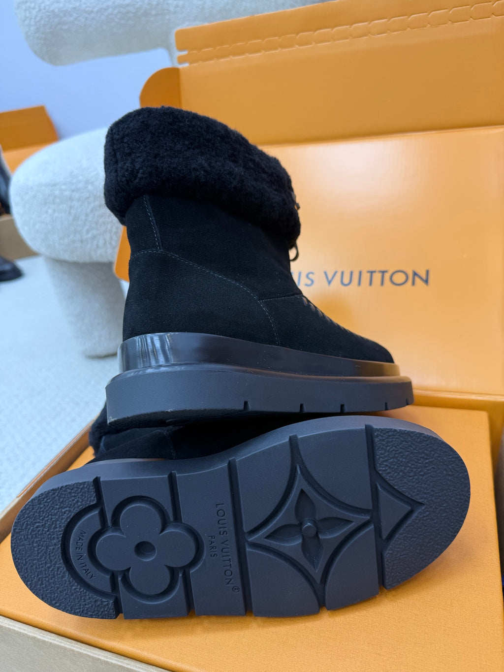 Dark navy high-top boots with shearling cuff and rubber outsole with patterned tread