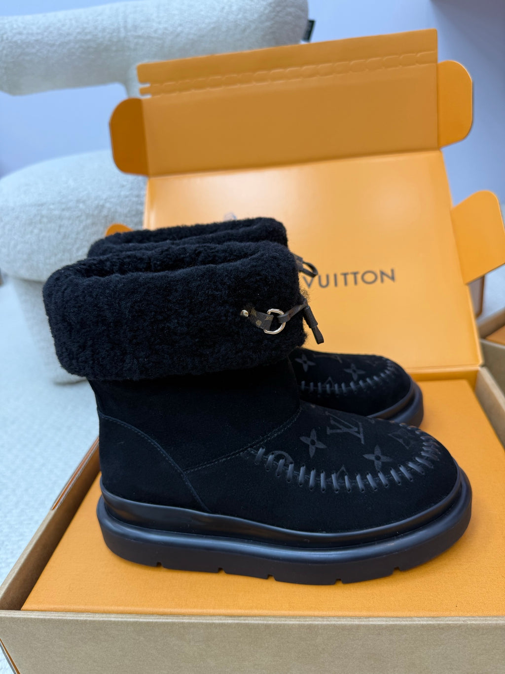 Dark navy suede high-top boot with shearling cuff and buckle strap on thick sole